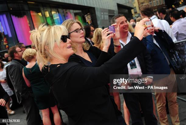 Deborra-Lee Furness takes photographs during the UK Premiere of The Wolverine, at the Empire Leicester Square, London.