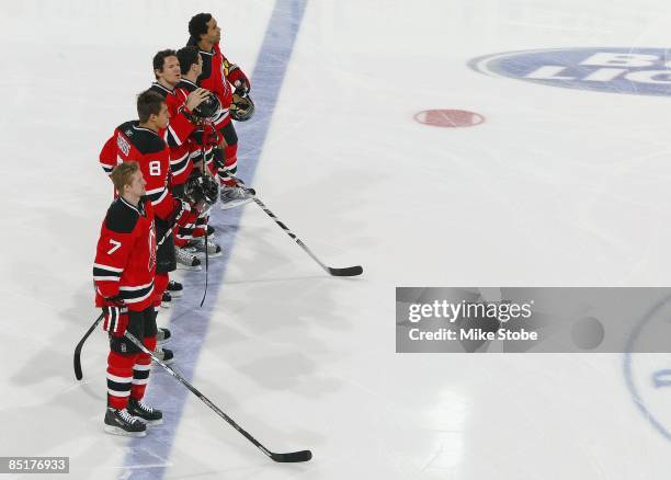 The starting lineup for the New Jersey Devils stand during the National Anthem prior to the game against Philadelphia Flyers at the Prudential Center...