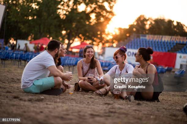 group of new friends finding something in common - music festival field stock pictures, royalty-free photos & images