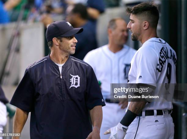 Manager Brad Ausmus of the Detroit Tigers cracks a smile while talking with Nicholas Castellanos of the Detroit Tigers during the second inning of a...