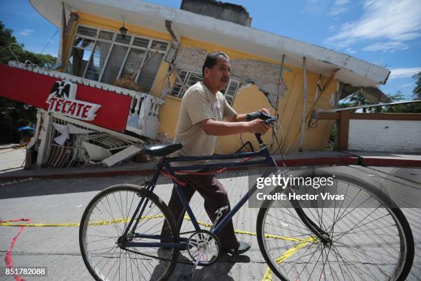 Man carries his bicycle three days after the magnitude 7.1 earthquake jolted central Mexico killing more than 250 hundred people, damaging buildings,...