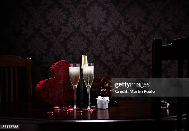 champange and roses and choclates on table  - wine gift stock pictures, royalty-free photos & images