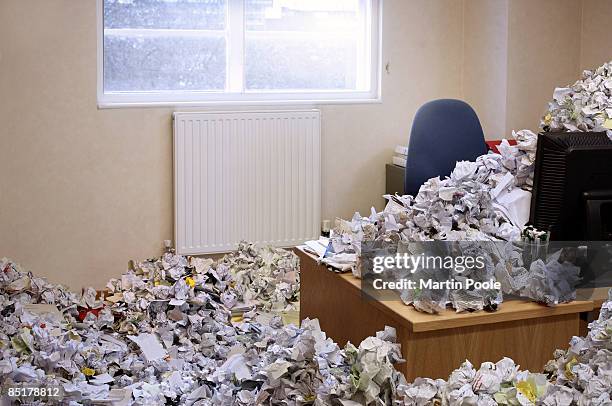 huge pile of rubbish covering office - eccesso foto e immagini stock