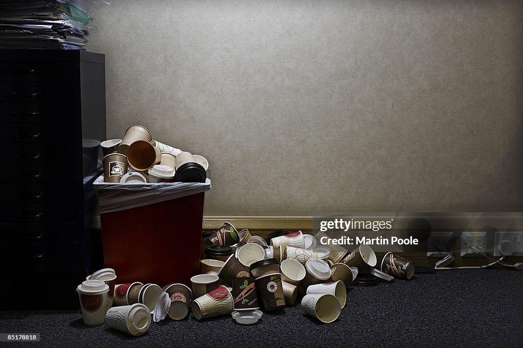 Pile of coffe cups in corner of office