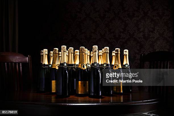 loads of champange bottles on living room  table - champagne stock pictures, royalty-free photos & images