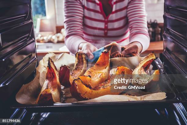 preparing pumpkins for roasting in the oven - roasted imagens e fotografias de stock