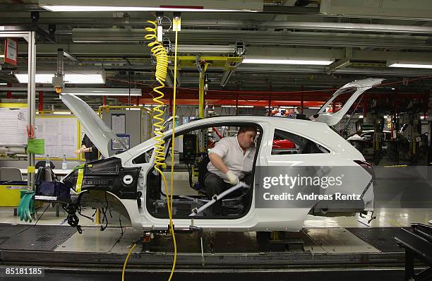 Workers assembling an Opel Corsa car at the plant of car maker Opel on March 2, 2009 in Eisenach, Germany. Opel announces a business plan directed to...