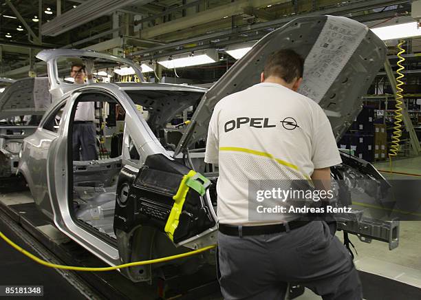 Workers assembling an Opel Corsa car at the plant of car maker Opel on March 2, 2009 in Eisenach, Germany. Opel announces a business plan directed to...