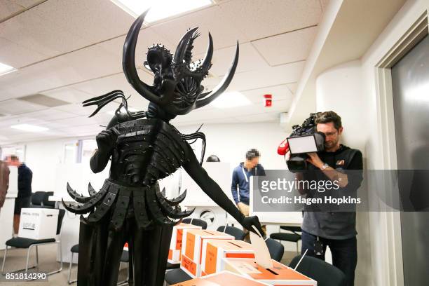 Tarikura Kapea, dressed in World of WearableArt garment 'Cambrian Regeneration' by Ran Xu of China, votes at Wellington City Library on September 23,...