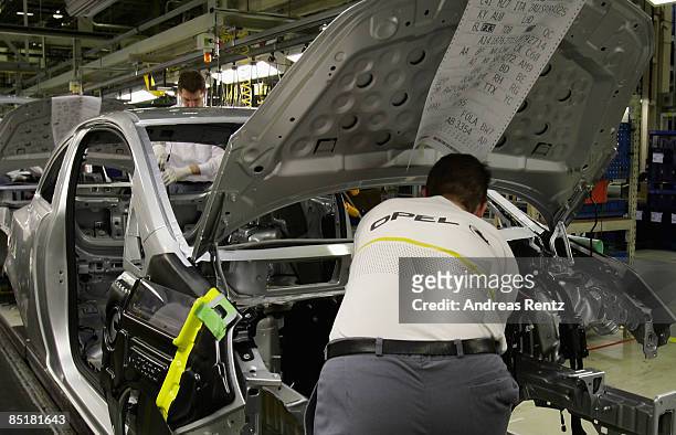 Workers assembling an Opel Corsa car at the plant of car maker Opel on March 2, 2009 in Eisenach, Germany. Opel announces a business plan directed to...