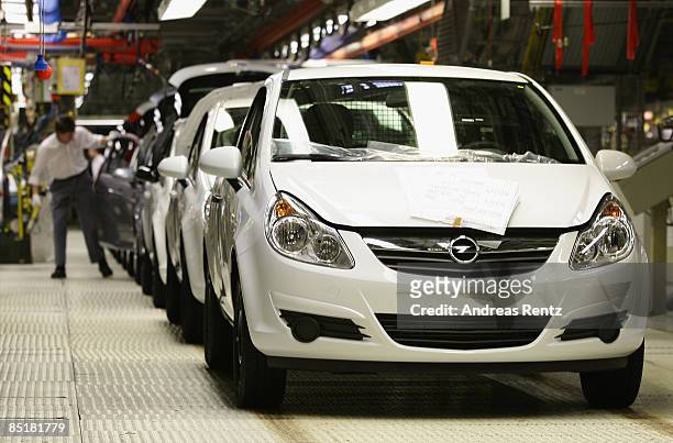 Workers assembling an Opel Corsa car at the plant of car maker Opel on March 2, 2009 in Eisenach, Germany. Opel announces a business plan directed to...