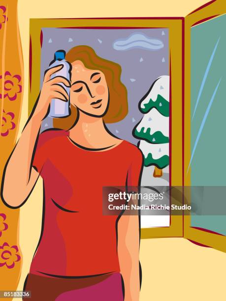 a hot and sweaty woman holding a cold bottle to her head in front of a window with snow outside - menopause stock illustrations