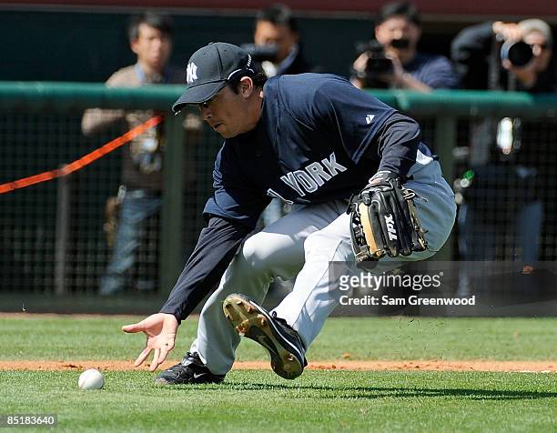 Infielder Doug Bernier of the New York Yankees makes a play during a spring training game against the Houston Astros at Osceola County Stadium on...