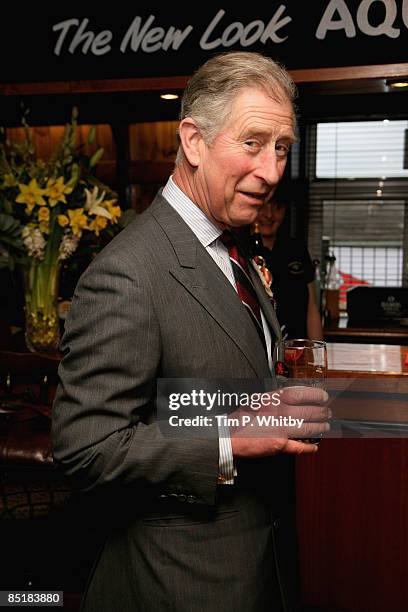 Prince Charles, Prince of Wales enjoys a pint of beer while he meets local people at The Viaduct Pub during his visit to Froncysyllte, winner of the...