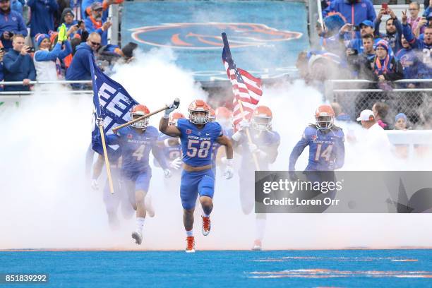 Linebacker Tyson Maeva of the Boise State Broncos leads his team onto the field prior to the start of first half action between the Virginia...