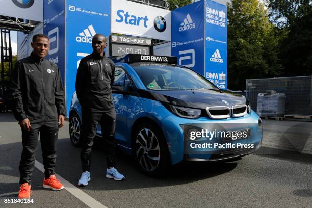 Kenenisa Bekele from Ethiopia and Eliud Kipchoge from Kenya pose for the cameras at the starting line. The leading male and female runners for the...