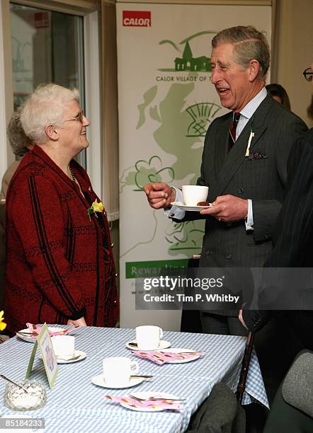 Prince Charles, Prince of Wales enjoys a cup of tea while meeting local people at the Froncysyllte Community Centre during his visit to Froncysyllte,...