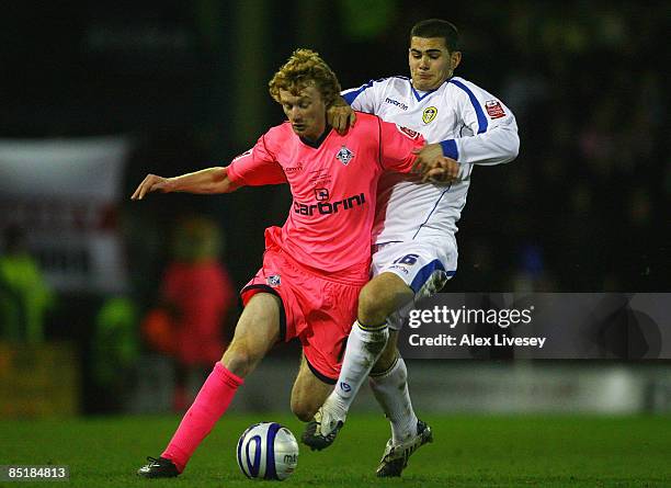 Chris Taylor of Oldham Athletic is tackled by Bradley Johnson of Leeds United during the Coca-Cola League One match between Oldham Athletic and Leeds...