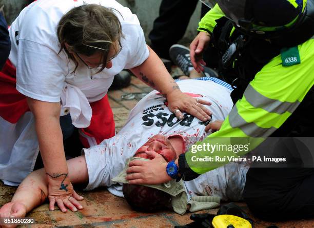 Member receives first aid from the police after being injured during a EDL march at Centenary Square in Birmingham.