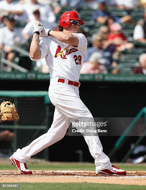 Colby Rasmus of the St. Louis Cardinals doubles in the first inning against the Florida Marlins during a spring training game at Roger Dean Stadium...