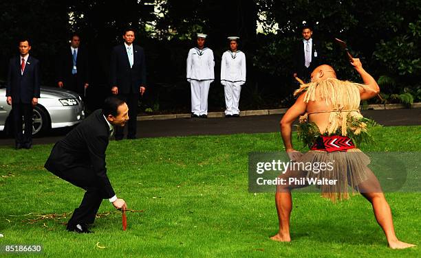 President of the Republic of Korea, Lee Myung-bak accepts the rautapu, a symbolic offering of peace laid down by Marshall Cook during the Powhiri, a...