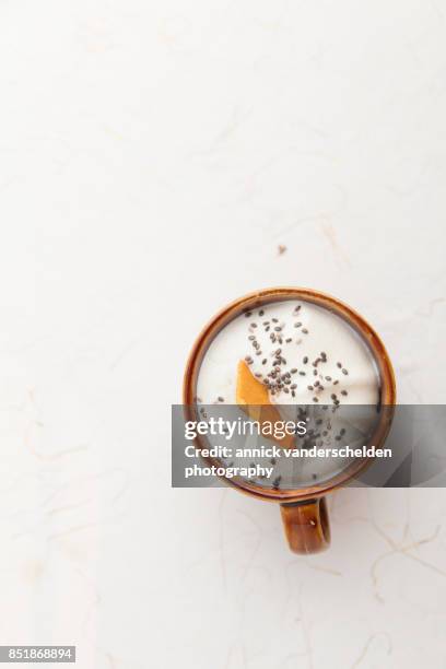 brown cup with whipped cream, chia seeds and dried mango. - mucilagem - fotografias e filmes do acervo