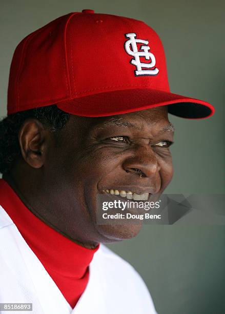 Hall of Fame baseball player Lou Brock of the St. Louis Cardinals sits on the bench and watches the Cardinals take on the Tampa Bay Rays during a...