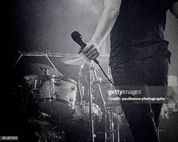 singer holding microphone on stage - rock music concept stock pictures, royalty-free photos & images