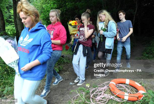 Friends of the two teenagers who drowned throw flowers in the river where Tonibeth Purvis from Barmston, Washington, Tyne and Wear, and Chloe Fowler...