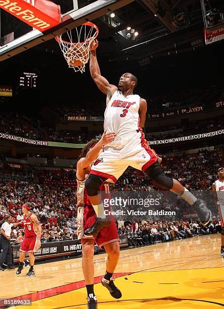 Dwyane Wade of the Miami Heat dunks against the Cleveland Cavaliers on March 2, 2009 at the American Airlines Arena in Miami, Florida. NOTE TO USER:...
