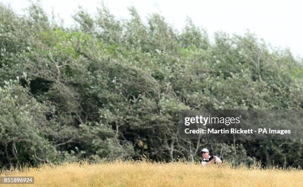 Mark McNulty plays out of the rough on the 1st fairway, during the Senior Open Championship at Royal Birkdale, Southport.