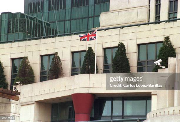 Union Jack flag waves September 21, 2000 atop of the British Intelligence MI6 headquarters in London, United Kingdom. A missile shattered an eighth...