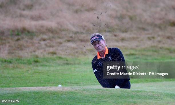 Germany's Bernhard Langer watches his ball roll back into the bunker as he dropped 2 shots on the last hole, during the Senior Open Championship at...