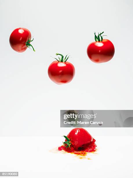 cherry tomatoes on white in suspension. - cherry tomato stock pictures, royalty-free photos & images