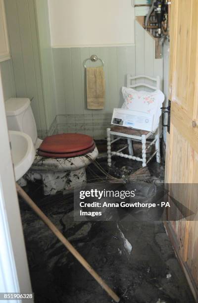 General view of the flood damaged toilet in Richard Mountain's house after flash floods in Walsden, near Todmorden, West Yorkshire.