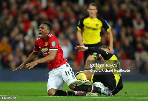 Anthony Martial of Manchester United is tackled by Tom Naylor of Burton during the Carabao Cup Third Round match between Manchester United and Burton...