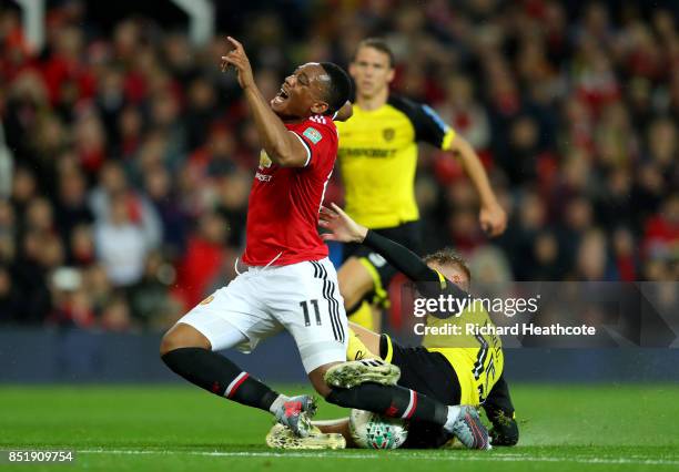 Anthony Martial of Manchester United is tackled by Tom Naylor of Burton during the Carabao Cup Third Round match between Manchester United and Burton...