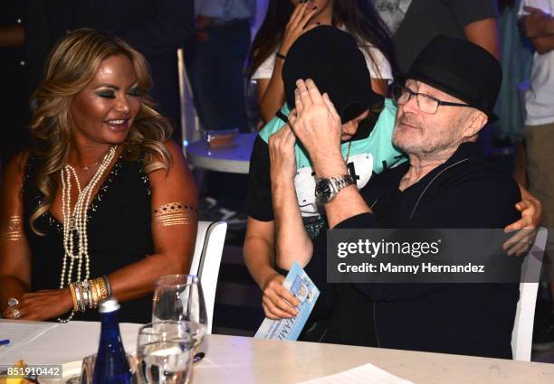 Orianne Collins, Phil Collins with fan attends Little Dreams Foundation Music Auditions in Design District on September 20, 2017 in Miami, Florida.