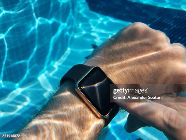 using smart watch in the swimming pool underwater - competitive intelligence stock pictures, royalty-free photos & images