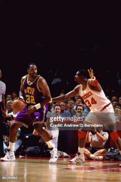 Karl Malone of the Utah Jazz posts up against Hakeem Olajuwon of the Houston Rockets during Game Two of the Western Conference Finals played on May...
