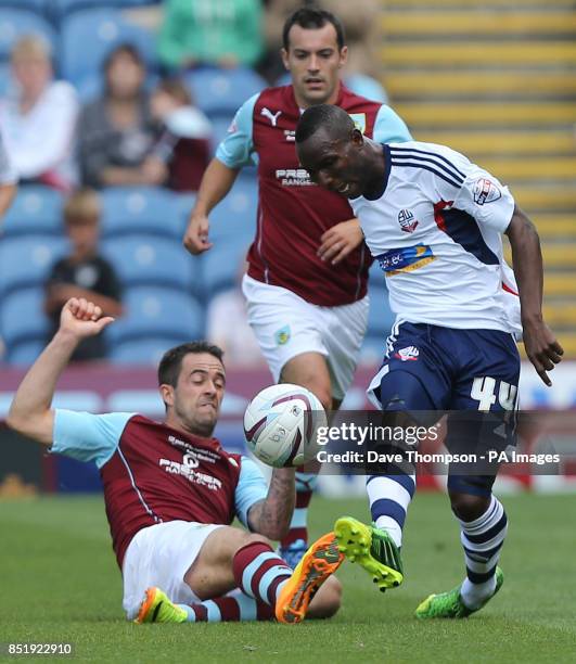 Burnley's Danny Ings, left, tackles Bolton Wanderers Mohamed Medo Kamara during the Sky Bet Championship match at Turf Moor, Burnley.