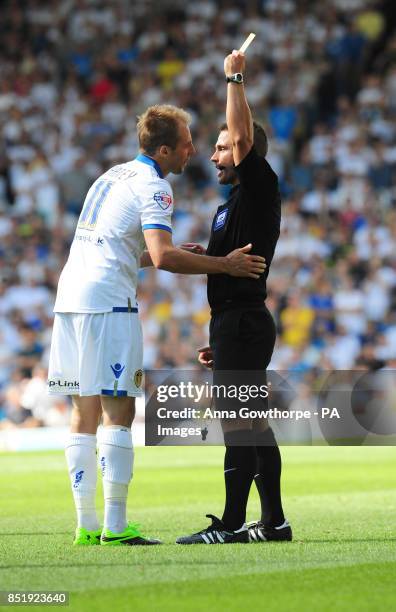 Leeds United's Luke Varney is booked by referee James Adcock during the Sky Bet Championship match at Elland Road, Leeds.