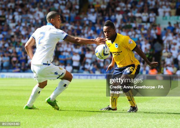 Leeds United's Lee Peltier and Brighton & Hove Albion's Kazenga Lualua in action during the Sky Bet Championship match at Elland Road, Leeds.