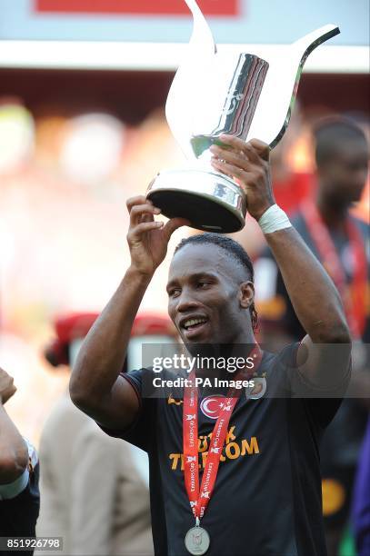 Galatasaray's Didier Drogba celebrates with the Emirates Cup