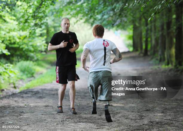 Lance Bombardier James Simpson of the Royal Artillery with head coach Michael Cohen during a training session in woods near Otley, Leeds ahead, of...