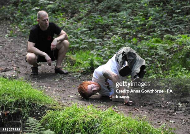 Lance Bombardier James Simpson of the Royal Artillery with head coach Michael Cohen during a training session in woods near Otley, Leeds ahead, of...