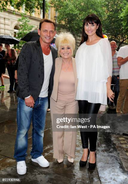 Perry Fenwick, Barbara Windsor and Emma Barton arrive for a performance of Spamalot at the Playhouse Theatre in London.