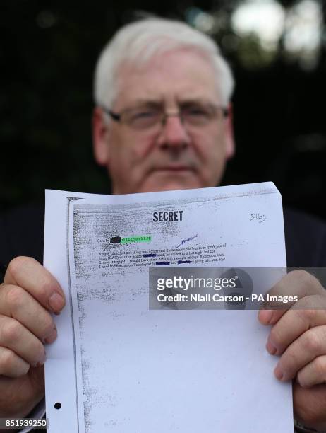 Michael Gallagher, who lost his son Aidan in the Omagh bomb attack, holds a redacted email from a Real IRA mole during a press conference on behalf...