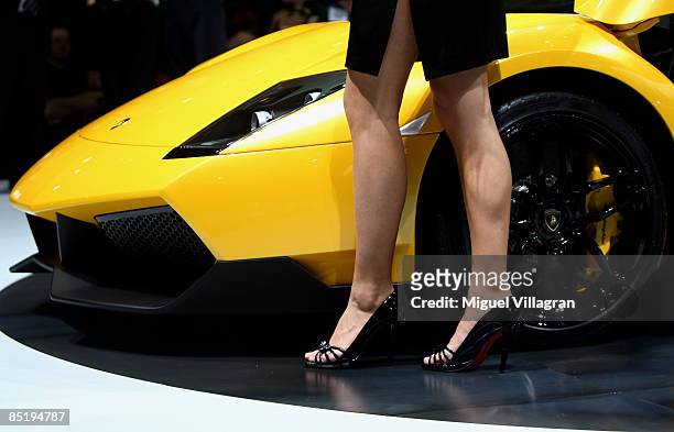 Woman poses next to the new Lamborghini Murcielago LP 670-4 during the first press day at the 79th Geneva International Motor Show on March 3, 2009...