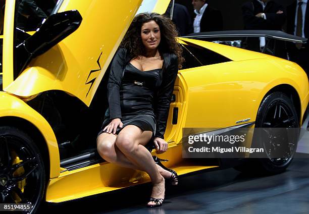 Woman poses next to the new Lamborghini Murcielago LP 670-4 during the first press day at the 79th Geneva International Motor Show on March 3, 2009...